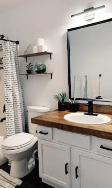 Shaker vanity, butcher-block top, floating shelves.