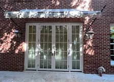 White French entry doors on a brick home.