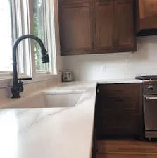 Walnut shaker cabinets, white marble counter.