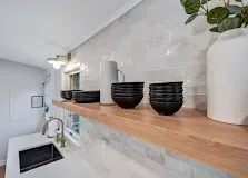 Built-in pantry shelving with tall doors and brushed hardware.