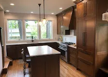 Custom kitchen with white-oak shaker doors and a quartz island.