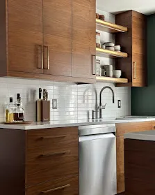 A custom Builders Corner kitchen: walnut shaker cabinetry, white marble counter, natural light.