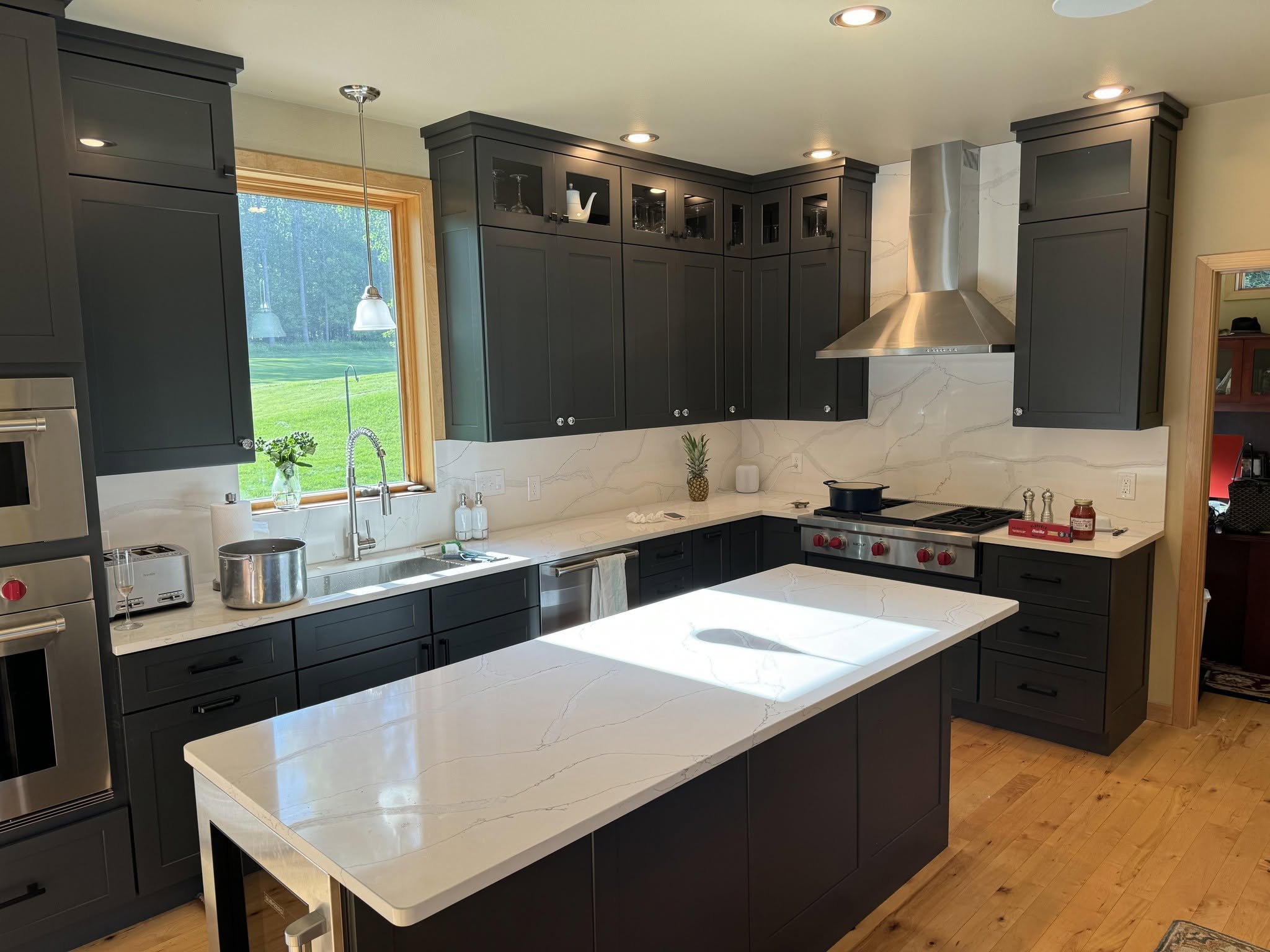 Dark charcoal shaker kitchen with marble island at Builders Corner.